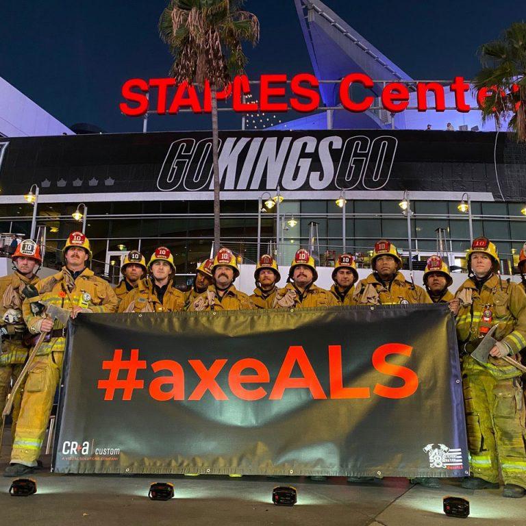 Firefighters holding a banner with a hashtag.